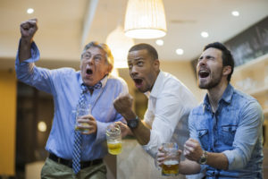 men cheering watching horse races