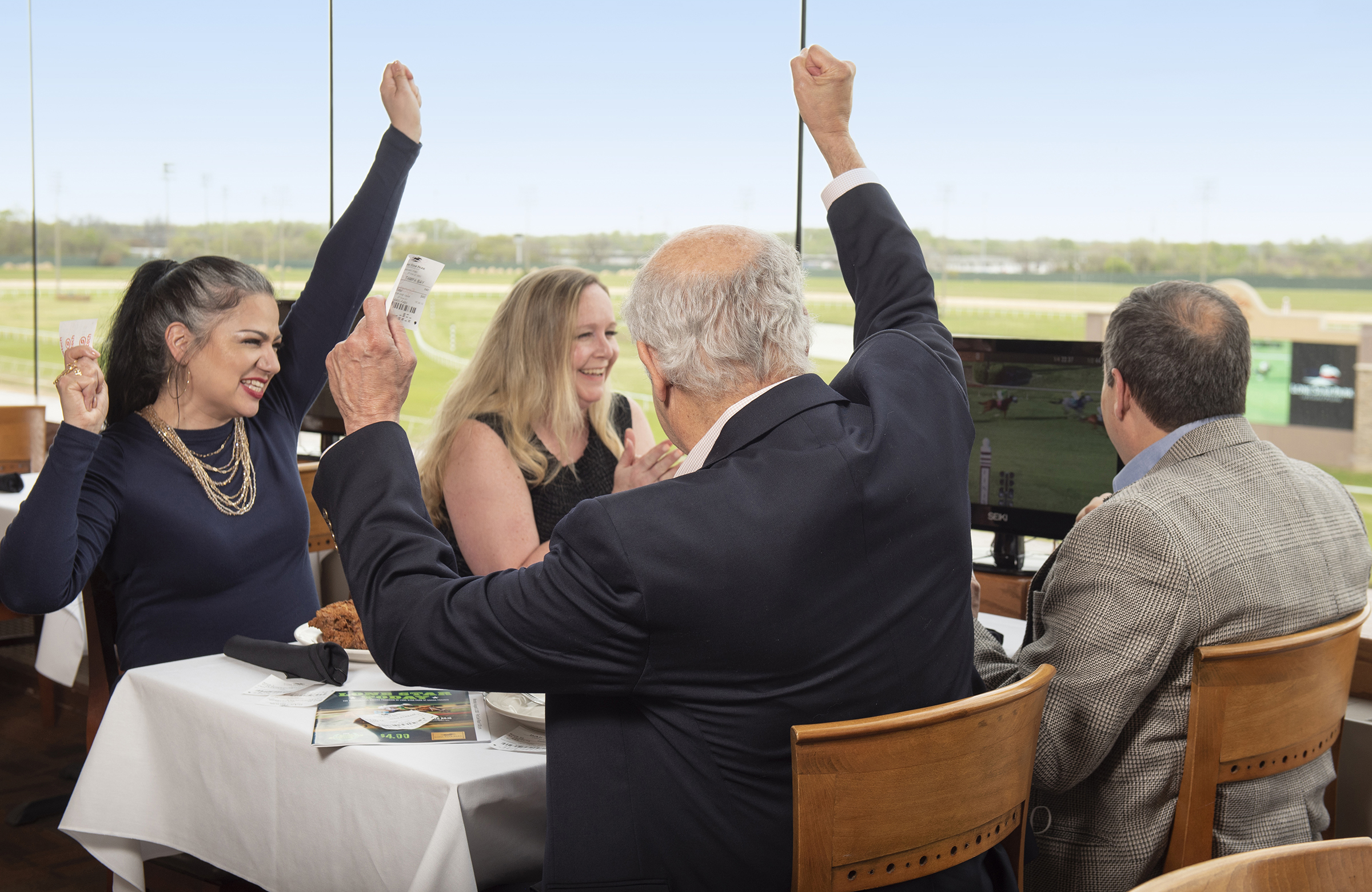 family watching horse races in silks at lone star park in grand prairie